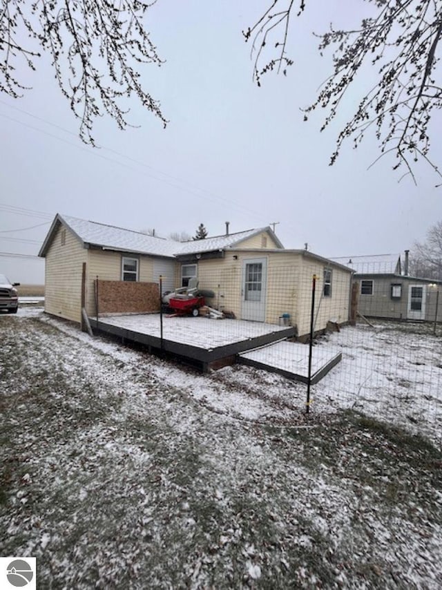 view of snow covered rear of property