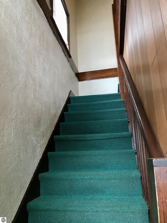 staircase with wooden walls