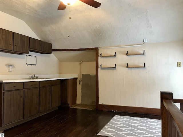 kitchen featuring dark hardwood / wood-style floors, lofted ceiling, sink, ceiling fan, and dark brown cabinetry