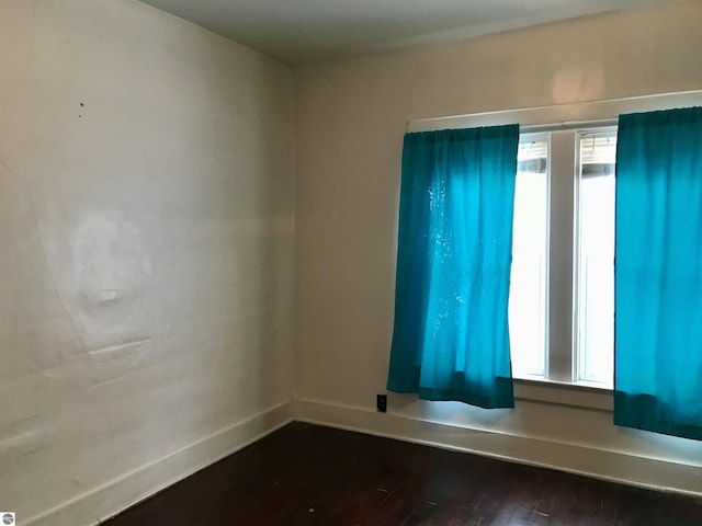 spare room with hardwood / wood-style flooring and a healthy amount of sunlight