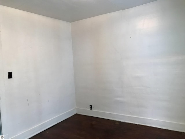 empty room featuring dark wood-type flooring