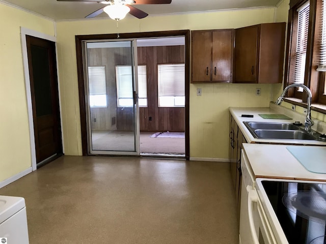 kitchen with crown molding, sink, white electric stove, dark brown cabinetry, and ceiling fan