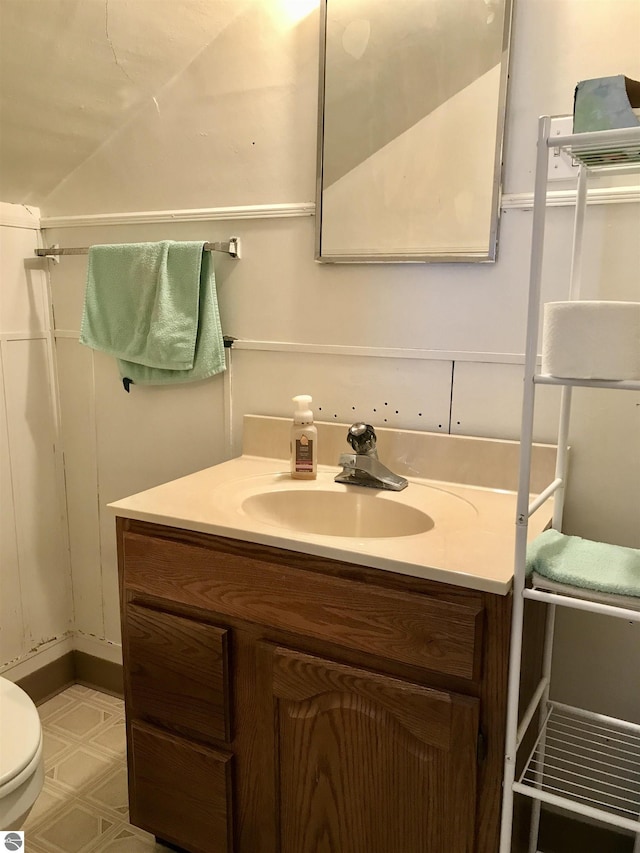 bathroom featuring vanity and toilet