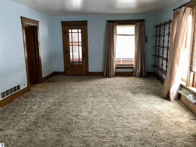 interior space with a healthy amount of sunlight and carpet floors