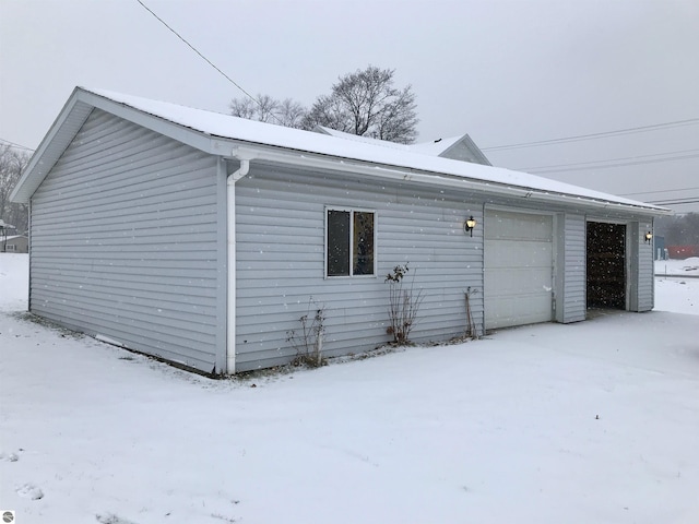 snow covered property featuring a garage