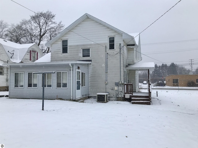 snow covered property featuring cooling unit