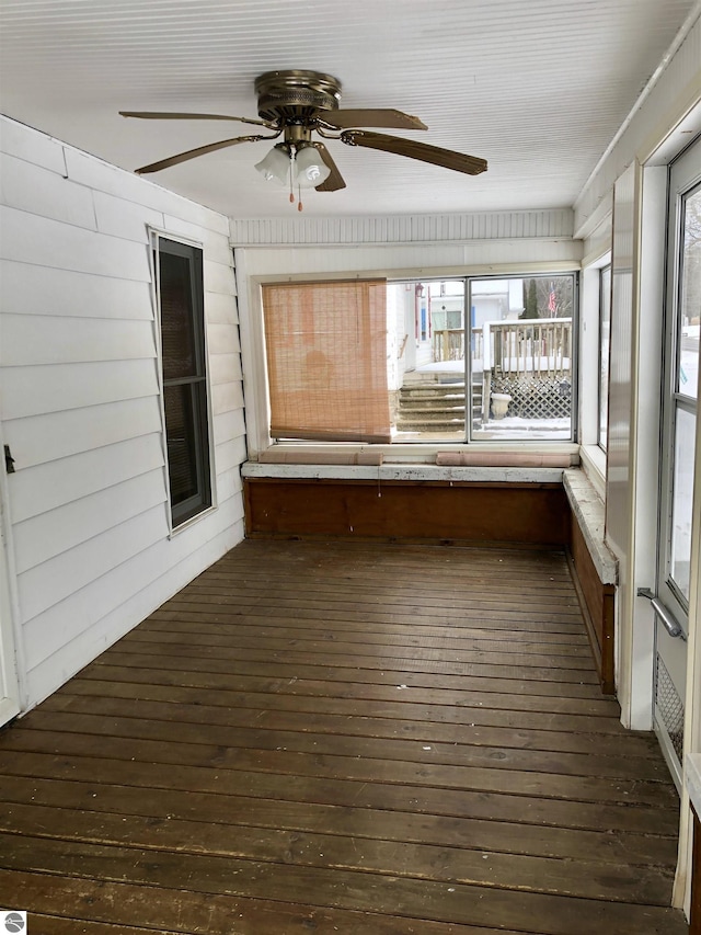 unfurnished sunroom featuring a wealth of natural light and ceiling fan