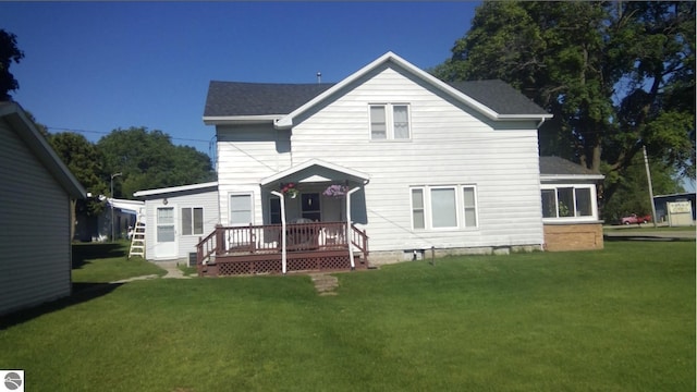 rear view of property featuring a lawn