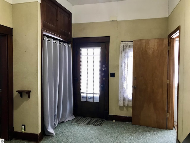 view of carpeted foyer entrance