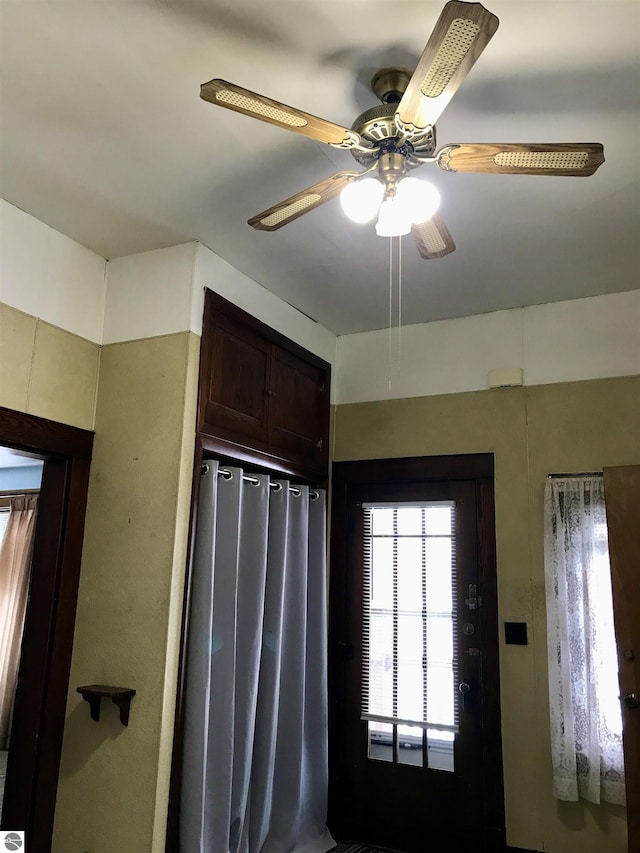 interior space with ceiling fan