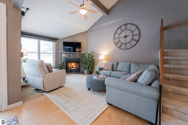 living room with hardwood / wood-style floors, ceiling fan, and lofted ceiling with beams