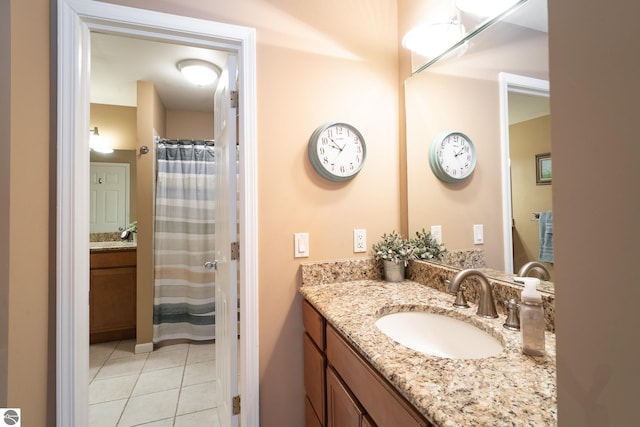 bathroom featuring tile patterned flooring, vanity, and a shower with curtain