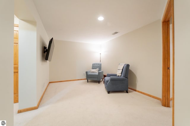 living area with light colored carpet