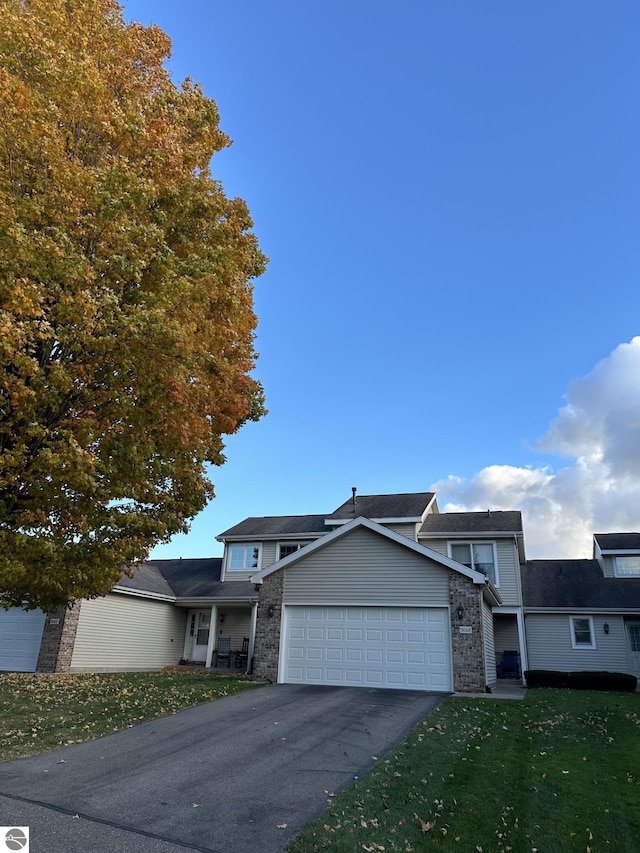 view of front of house featuring a front yard and a garage