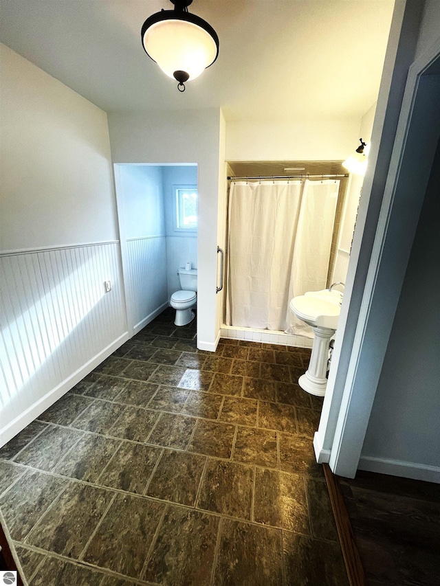 bathroom with toilet and walk in shower