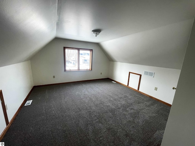 bonus room with carpet floors and lofted ceiling