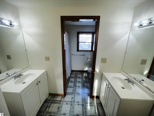 bathroom featuring vanity and toilet