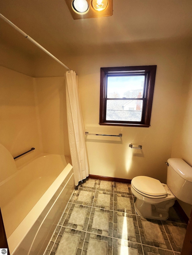 bathroom with shower / tub combo and toilet