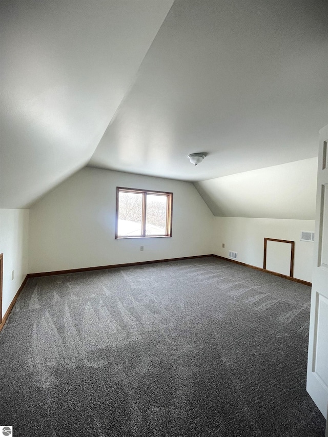 bonus room with carpet flooring and lofted ceiling