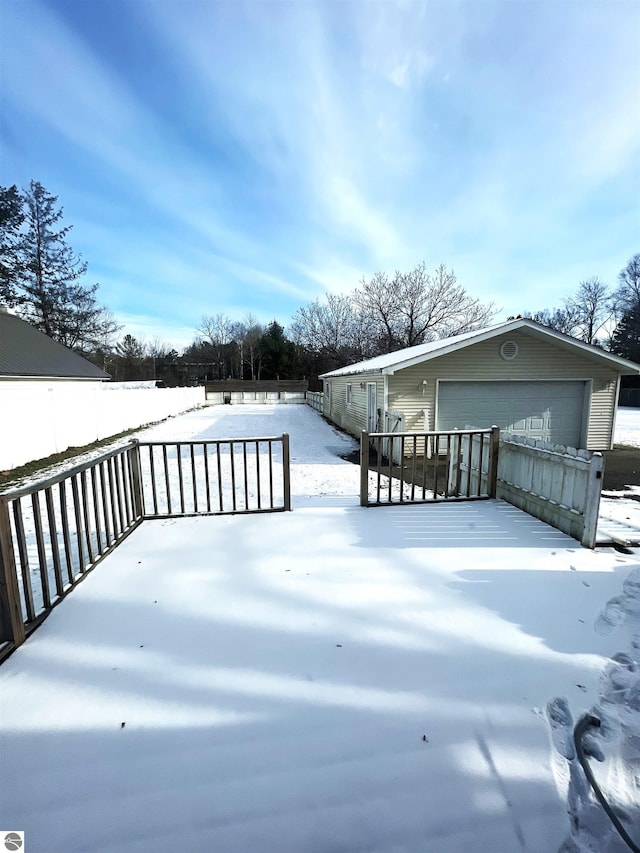 snow covered deck with a garage