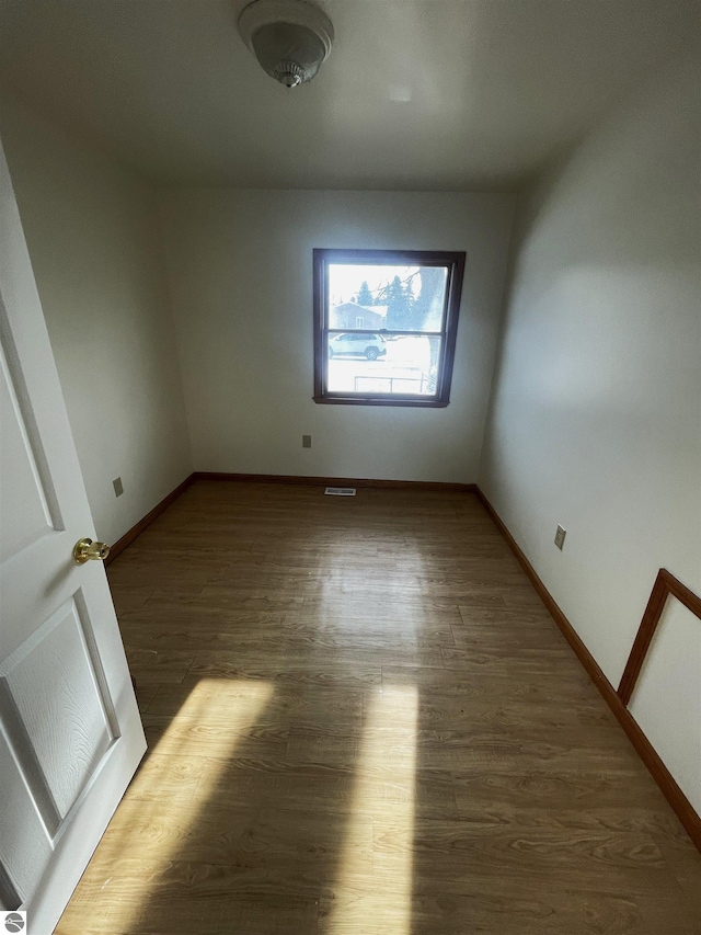 unfurnished room featuring dark hardwood / wood-style flooring