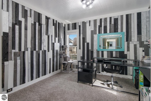 carpeted home office with a textured ceiling