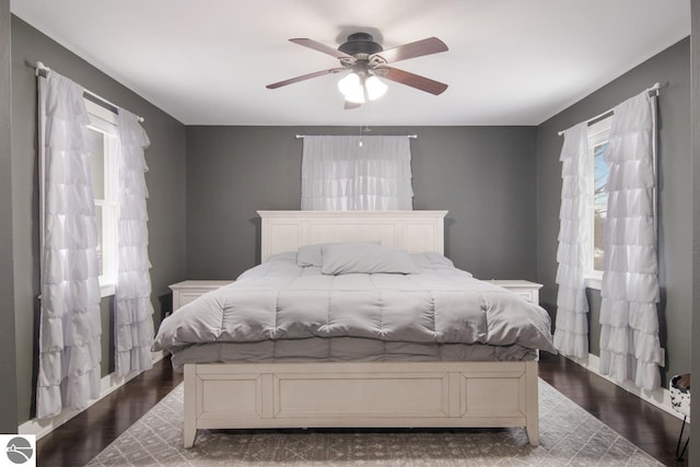 bedroom featuring ceiling fan and dark hardwood / wood-style flooring