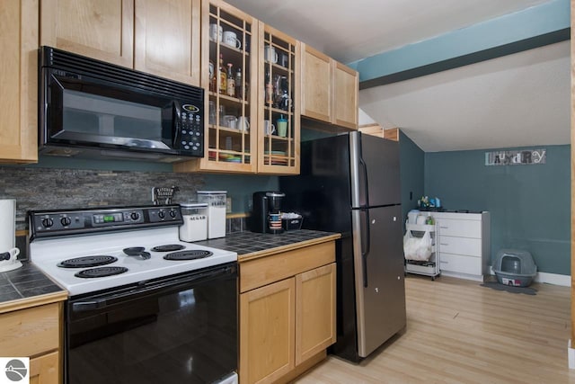 kitchen featuring stainless steel refrigerator, electric stove, tile countertops, and light brown cabinets