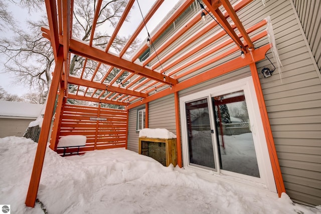 snow covered patio with a pergola