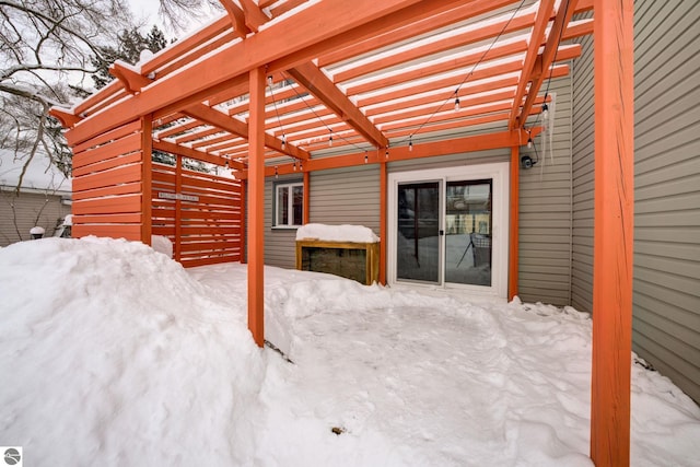 snow covered patio featuring a pergola