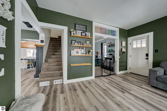 foyer entrance with light hardwood / wood-style flooring