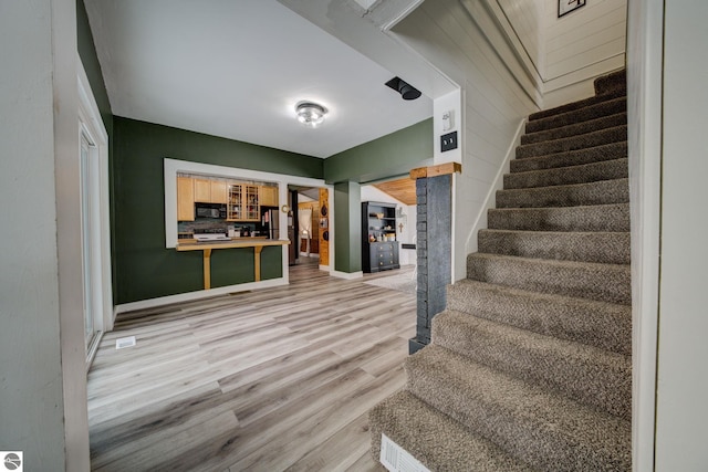 staircase featuring wood-type flooring