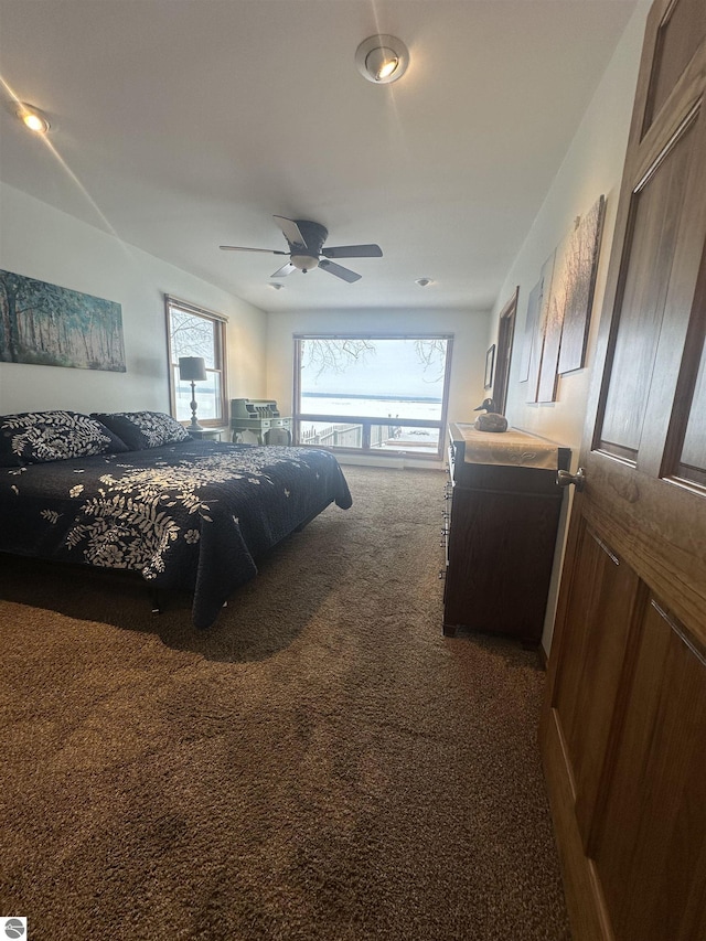 bedroom featuring dark colored carpet and ceiling fan