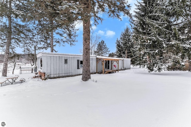 view of snow covered rear of property