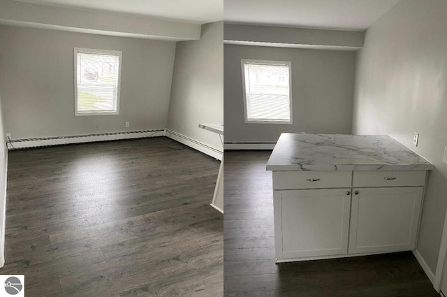 spare room with dark wood-type flooring and a baseboard radiator