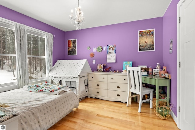 bedroom with a notable chandelier and hardwood / wood-style floors