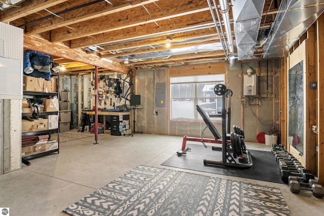 basement featuring electric panel and water heater