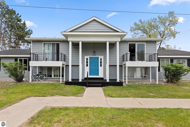 view of front of property with a balcony and a front lawn