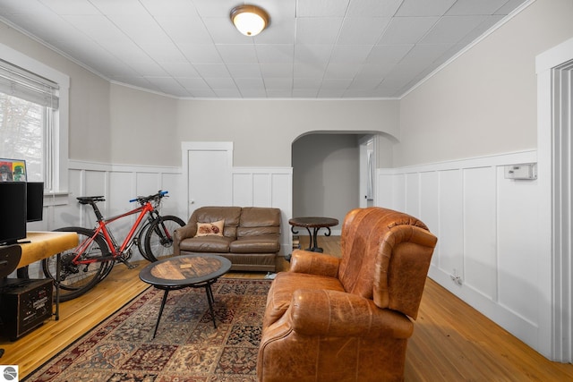 living room with hardwood / wood-style flooring and ornamental molding