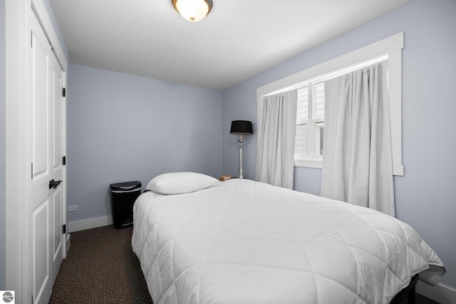 bedroom featuring dark colored carpet