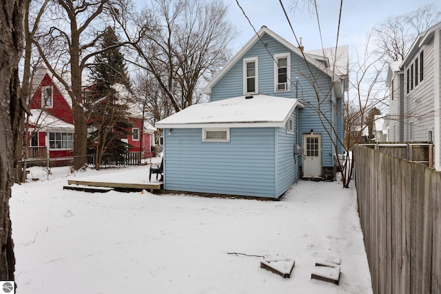 snow covered house with a deck