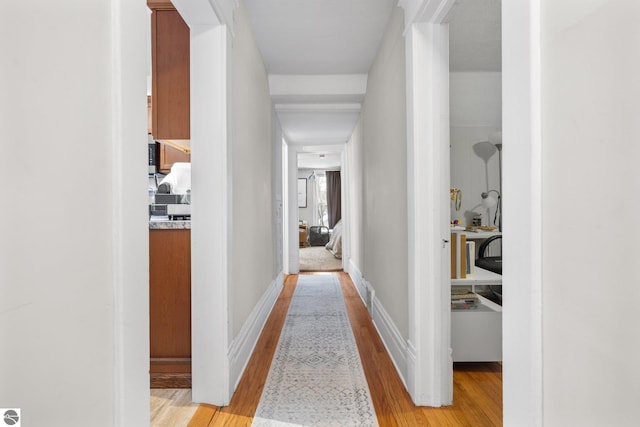 corridor with light hardwood / wood-style flooring