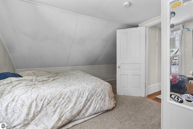 carpeted bedroom featuring lofted ceiling