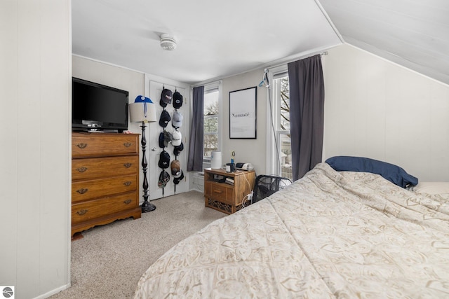 carpeted bedroom with lofted ceiling