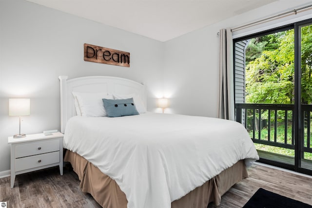 bedroom featuring hardwood / wood-style floors and multiple windows