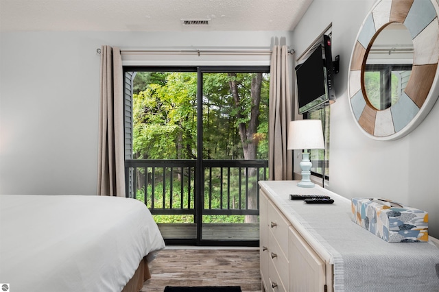 bedroom featuring a textured ceiling and light wood-type flooring