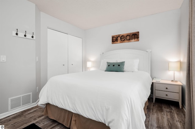 bedroom with a closet and dark hardwood / wood-style floors