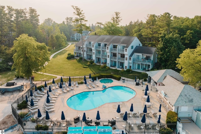 view of pool with a lawn and a patio