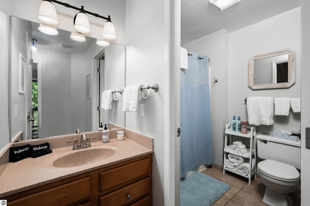 bathroom featuring a shower with shower curtain, tile patterned flooring, vanity, and toilet