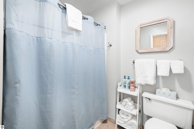 bathroom with walk in shower, tile patterned flooring, and toilet